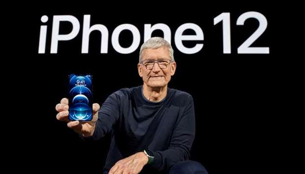 Apple CEO Tim Cook poses with the all-new iPhone 12 Pro at Apple Park in Cupertino, California, US in a photo released Tuesday