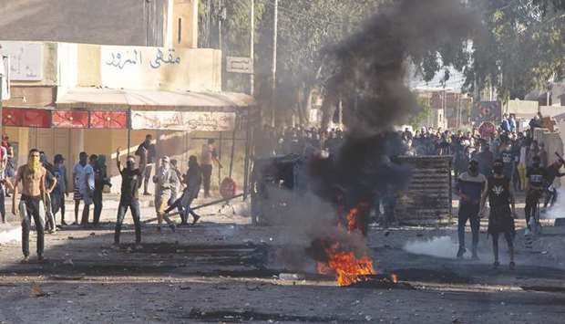 Tunisian protesters take to the streets of the impoverished town of Sbeitla, yesterday after a man died when authorities demolished an illegal kiosk where he was sleeping.