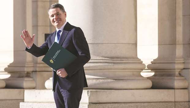 Irelandu2019s Finance Minister Paschal Donohoe poses during a photocall prior to presenting the 2021 Irish budget to parliament, at Government Buildings in Dublin yesterday.
