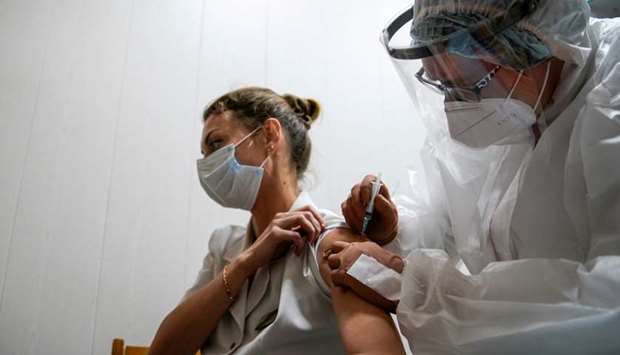 A medic at a Russian regional hospital in Tver receives the ,Sputnik-V, vaccine against the new coronavirus in Tver, Russia on October 12.