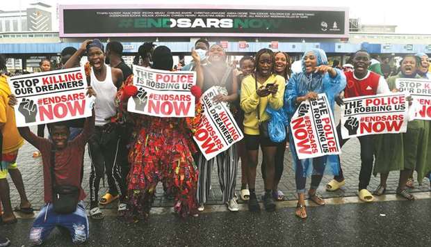 Demonstrators carry banners and shout slogans during a protest over alleged police brutality, in Lagos, yesterday.