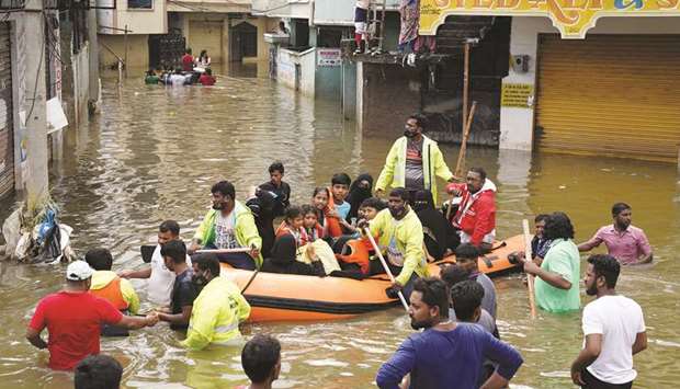 Residents are evacuated from a flooded neighbourhood after heavy rainfall in Hyderabad yesterday.60 killed as rains wreak havoc, crops damaged