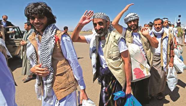 Freed Yemeni prisoners arrive in the rebel-held capital Sanaa, yesterday, as the country began swapping 1,000 prisoners in a complex operation overseen by the International Committee of the Red Cross.