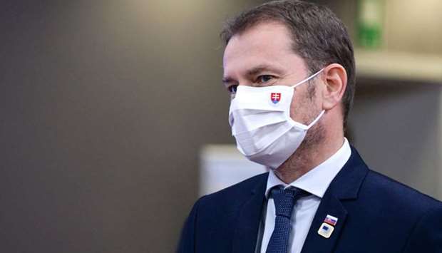 Slovakia's Prime Minister Igor Matovic leaves at the end of the two days face-to-face European Union (EU) summit at the European Council Building in Brussels yesterday. Matovic said Saturday that Slovakia will test every resident ages 10 and up for the coronavirus.