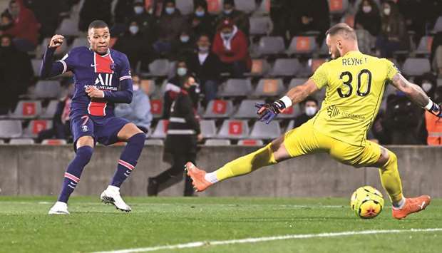 Paris Saint-Germainu2019s forward Kylian Mbappe (left) scores against Nimes during the Ligue 1 match in Nimes, France. (AFP)