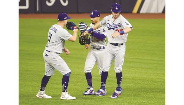 Los Angeles Dodgers left fielder Joc Pederson (left) celebrates with right fielder Mookie Betts (centre) and centre fielder Cody Bellinger after their 7-3 win against the Atlanta Braves in game five of the 2020 NLCS at Globe Life Field in Arlington, Texas. (USA TODAY Sports)