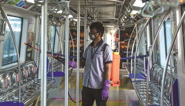 An employee sanitises a coach as the Mumbai Metro network prepares to resume services after more than a six-month shutdown due to the Covid-19 coronavirus pandemic, at the Andheri metro station yesterday.
