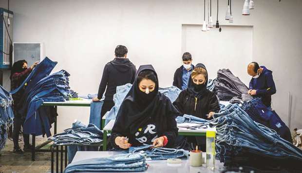 Teams of technicians and machinists in face masks carry out quality controls at fashion brand Koi, which uses fabric spun at a textile mill in Iranu2019s northwestern city of Khoy, eliminating the need for imported materials.