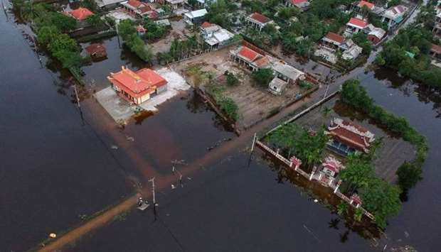 An aerial picture taken on October 15 shows houses submerged in flood waters caused by heavy rains in Hai Lang district in central Vietnam's Quang Tri province