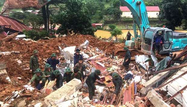 Military personnel searching for missing soldiers at the site of a landslide in central Vietnam's Quang Tri province.