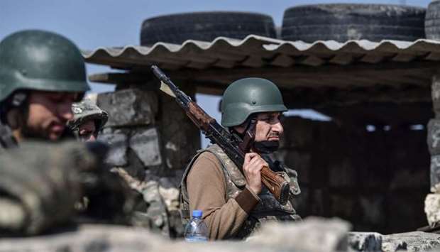 An Armenian soldier stands at the front line as troops hold positions on during the ongoing fighting between Armenia and Azerbaijan over the disputed region.