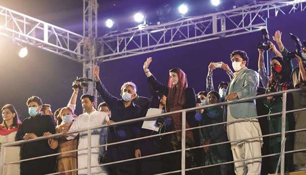 CENTRE-STAGE: PPP chairman Bilawal Bhutto Zardari (in light green blazer), and PML-N vice president Maryam Nawaz during an anti-government protest rally in Karachi yesterday. (Reuters)