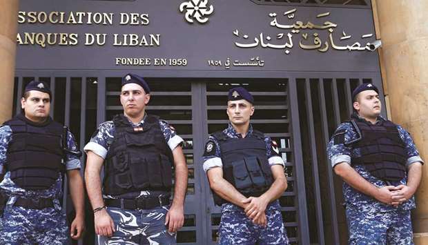 Lebanese police stand outside the entrance to the Association of Banks in downtown Beirut, Lebanon (file). The IMF said Lebanon was heading towards a contraction by 25%, compared with an estimated shrinkage of 12% in April.
