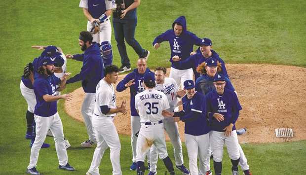 Los Angeles Dodgers players celebrate after defeating the Atlanta Braves in Arlington, Texas, on Sunday. (USA TODAY Sports)