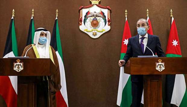 Jordan's Foreign Minister Ayman Safadi (R) along with his Kuwaiti counterpart Sheikh Ahmad Nasser al