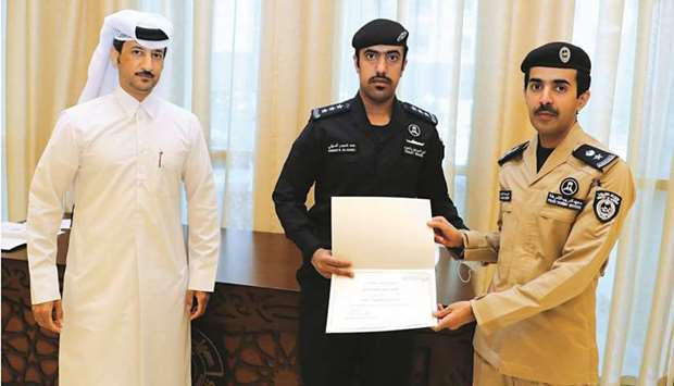 MoTC assistant undersecretary of Maritime Transport Affairs Dr Saleh bin Fetais al-Marri handing over training completion certificates.