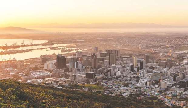 The port area stands beyond commercial high-rise properties as the sun rises in Cape Town (file). South Africa will be hard pressed to realise its ambitions of attracting 1tn rand ($61bn) of private investment in infrastructure if its past record is anything to go by.