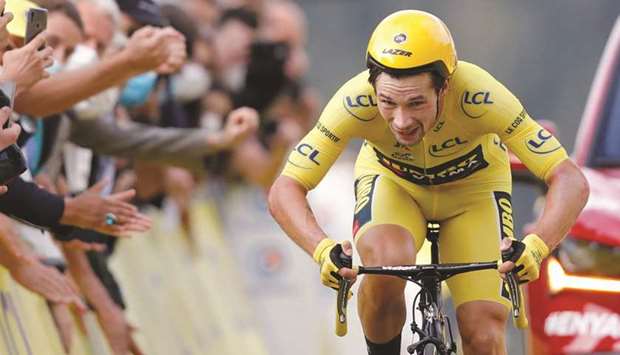 In this September 19, 2020, picture, Team Jumbo-Visma rider Primoz Roglic of Slovenia, wearing the overall leaderu2019s yellow jersey, finishes Stage 20 of the Tour de France in La Planche des Belles Filles, France. (Reuters)