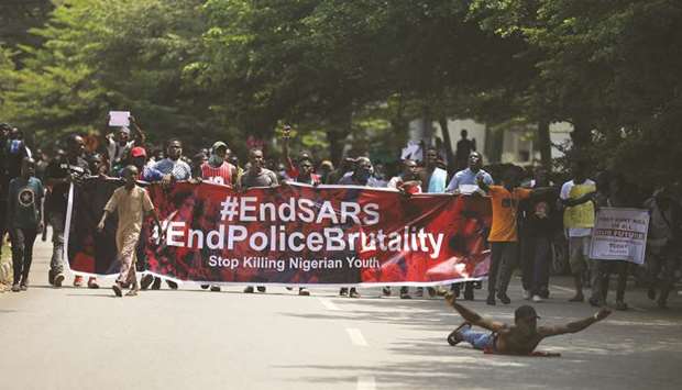 Protesters carry a banner during a demonstration to press for the scrapping of Special Anti-Robbery Squad (SARS) on Abuja-Keffi Expressway, yesterday.