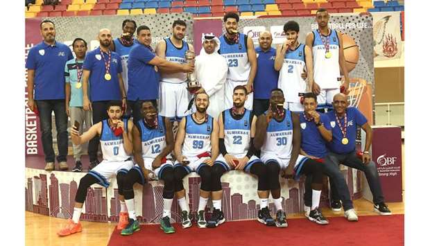Al Wakrah players and officials celebrate after their Qatar Cup triumph at the Al Gharafa Indoor Hall yesterday. PICTURES: Shemeer Rasheed