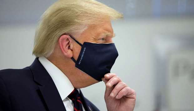 US President Donald Trump wears a protective face mask during a tour of the Fujifilm Diosynth Biotechnologies' Innovation Center, a pharmaceutical manufacturing plant where components for a potential coronavirus disease vaccine candidate are being developed, in Morrisville, North Carolina, US