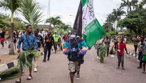 Protesters march at Alausa, the Lagos State Secretariat, in Lagos yesterday, after the Governor of Lagos State, Sanwo Olu, declared 24-hour curfew in Nigeria's economic hub Lagos as violence flared in widespread protests that have rocked cities across the country