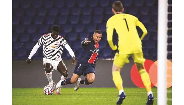 Paris Saint-Germainu2019s Kylian Mbappe (right) vies for the ball with Manchester Unitedu2019s Axel Tuanzebe during the UEFA Champions League Group H match at the Parc des Princes stadium in Paris, France, on Tuesday. (AFP)
