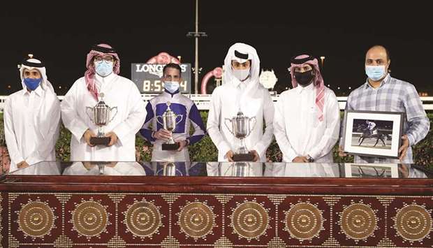Qatar Racing and Equestrian Club Racing manager Mohamed Khalid al-Khalifa (second from right) with the winners of Wathnan Cup after Khalifa bin Sheail al-Kuwariu2019s Shakour won the 1800m feature on dirt at Al Rayyan Park yesterday. PICTURES: Juhaim