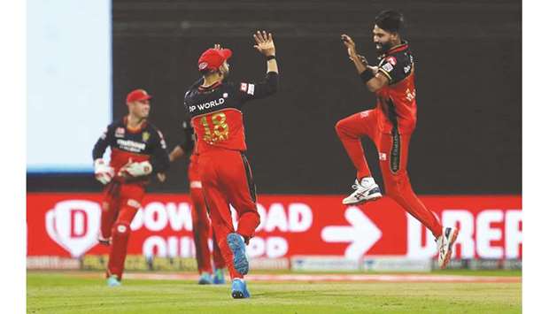 Royal Challengers Bangaloreu2019s fast bowler Mohammed Siraj (right) celebrates with captain Virat Kohli after dismissing Kolkata Knight Ridersu2019s Tom Banton (not in picture) during the Indian Premier League in Abu Dhabi yesterday. (Sportzpics for BCCI)