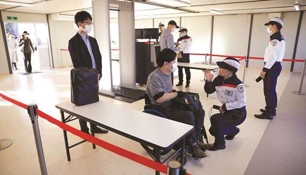 Security officers conduct a screening test, including Covid-19 countermeasures, for next yearu2019s Tokyo Olympic and Paralympic Games in Tokyo. yesterday. (Reuters)