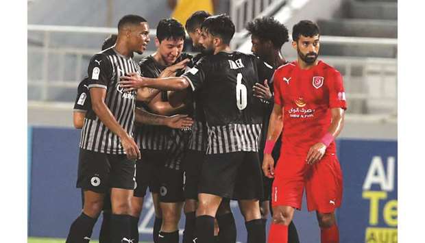 Al Saddu2019s Nam Tae-hee (second from left) celebrates his goal with teammates during the QNB Stars League match against Al Duhail yesterday.
