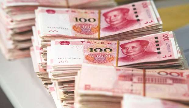 Bundles of 100 yuan notes at a bank in Shanghai. The onshore renminbi gained almost 4% in the three-month period ending September 30, the most since early 2008, while its offshore counterpart advanced more than 4%.