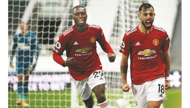 Manchester Unitedu2019s Bruno Fernandes (right) and Aaron Wan-Bissaka celebrate a goal during the English Premier League match against Newcastle United at St Jamesu2019 Park in Newcastle-upon-Tyne, England, on Saturday. (AFP)