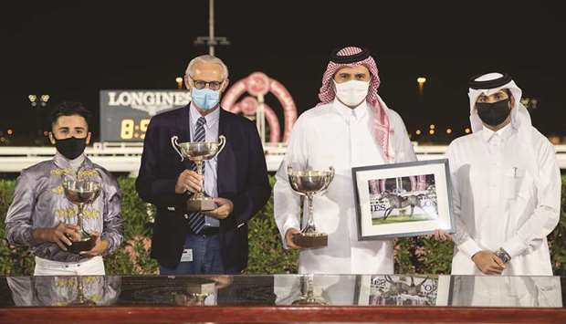 Qatar Racing and Equestrian Club Racing manager Mohamed Khalid al-Khalifa (right) with the winners of the Umm Bab Cup after Al Shaqab Racingu2019s Al Naama won the feature at Al Rayyan Park yesterday. PICTURES: Juhaim