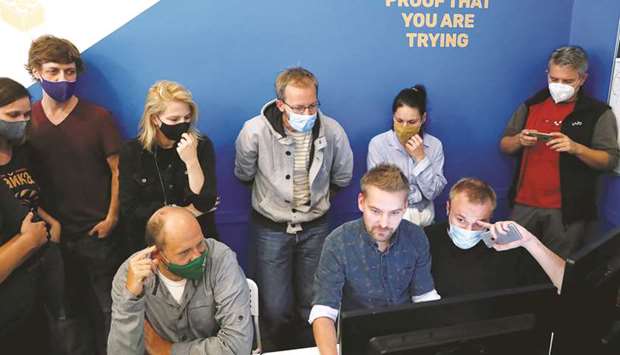 Editor-in-chief Munk (left) is seen in the editorial room amongst other journalists of the independent news website Telex before launching their new website in Budapest.