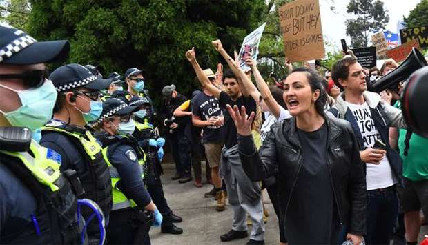 Protesters confront police during an anti-lockdown rally in Melbourne