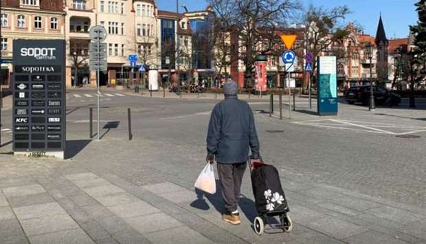 A man returns home after shopping during the outbreak of coronavirus disease (Covid-19) in Sopot, Poland
