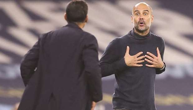 Manchester Cityu2019s Spanish manager Pep Guardiola gestures as he exchanges words with Portou2019s Portuguese coach Sergio Conceicao (left) during the UEFA Champions League Group C match in Manchester, United Kingdom, on Wednesday. (AFP)