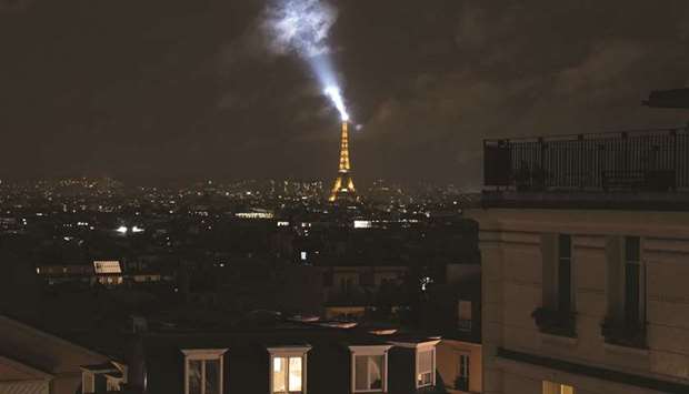 The Eiffel Tower is seen at night during the curfew in Paris.