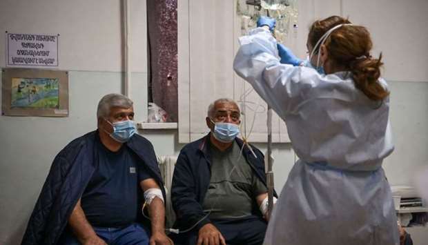 A medical staff gives treatment to patients that are suspected cases of the novel coronavirus Covid-19 in a hospital of the city of Stepanakert on October 22 during the ongoing fighting between Armenian and Azerbaijani forces over the breakaway region of Nagorno-Karabakh