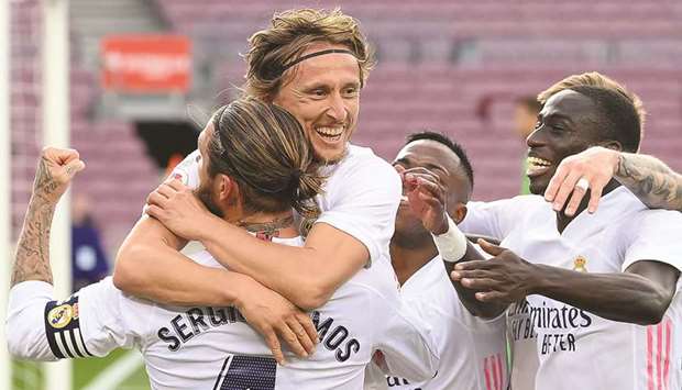 Real Madridu2019s Croatian midfielder Luka Modric (C) celebrates with teammates after scoring against Barcelona at the Camp Nou stadium in Barcelona.