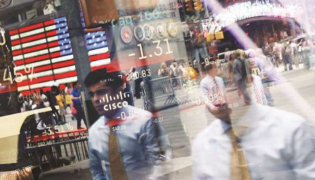 People are reflected in the window of the Nasdaq MarketSite in Times Square. In a week where benchmark indexes all but sat still, evidence of bond-market influence stood out among rate-sensitive stocks after 10-year yields spiked.