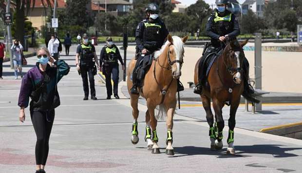 Police patrol on horseback along the St Kilda Esplanade in Melbourne as Australian health officials reported no new coronavirus cases or deaths in Victoria state, which has spent months under onerous restrictions after becoming the epicentre of the country's second wave