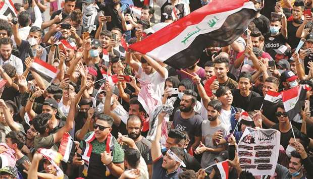 Iraqi demonstrators gather to mark the first anniversary of the anti-government protests in Baghdad, yesterday.