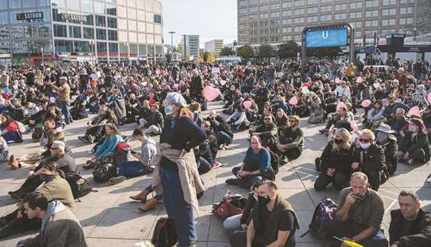 People take part yesterday in a rally against coronavirus restrictions at Berlinu2019s Alexanderplatz.