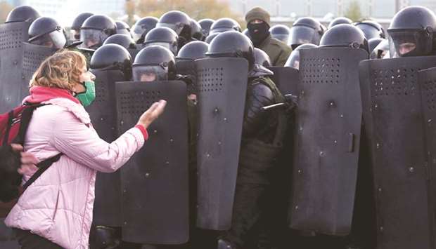 A woman argues with law enforcement officers during an opposition rally in Minsk.