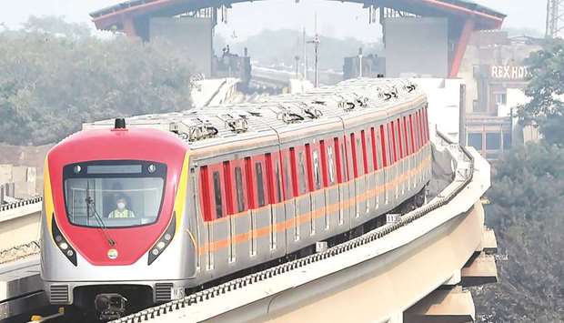 A newly built Orange Line Metro Train (OLMT), a metro project planned under the China-Pakistan Economic Corridor, driving through on a track after its opening in Lahore yesterday. (AFP)