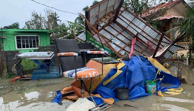 A destroyed house lies on its side after tropical storm Molave hit the town of Pola, Oriental Mindoro province