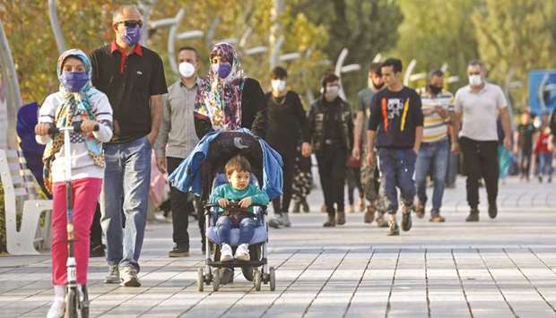 Iranian people wear masks, amid a rise in the coronavirus disease (Covid-19) infections, in West Tehran.