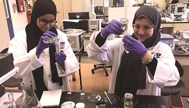 QU-YSC students engaged in an experiment.